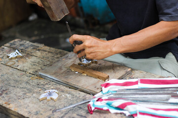 carpenter holding hammer and nail