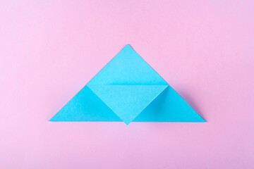 DIY and kid's creativity, origami. Step by step instruction: how to make bookmark easter bunny. Step3  Bend top of triangle to middle of lower side. Easter craft.