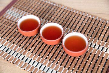 Three bowls of black tea in a row