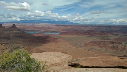 Fototapeta na wymiar Viewpoint overlooking Potash Ponds and the La Sal mountains in the distance at Dead Horse Point, Utah