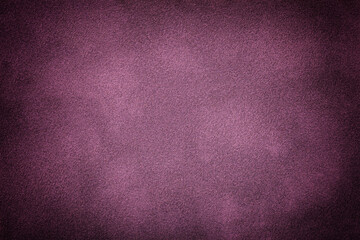 Purple matte background of suede fabric with vignette. Texture of velvet textile