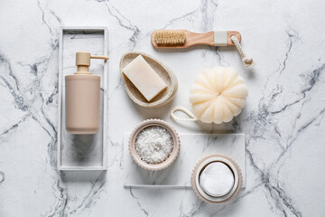 Composition with bath accessories and cosmetics on light background