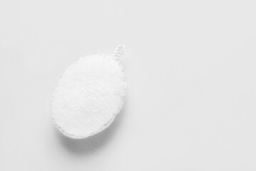 Loofah on light background, top view