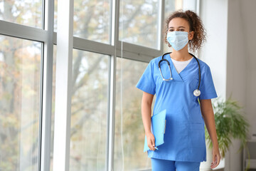 Portrait of female doctor wearing medical mask in clinic