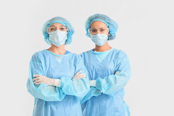 Portrait of female surgeons on light background