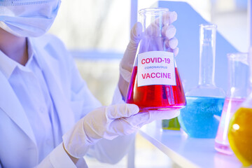 Scientist with covid-19 vaccine in laboratory