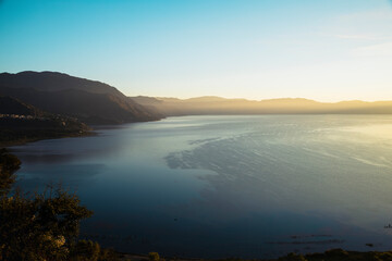 Sunrise at Lake Atitlán surrounded by mountains - sunrise landscape at lake in Guatemala