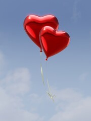 Fototapeta na wymiar Two red heart balloons in the cloudy blue sky