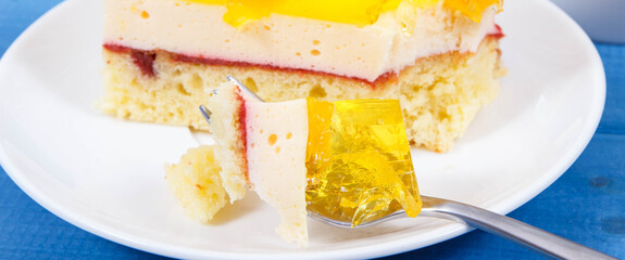 Creamy sweet sponge cake with layers and jelly. Festive dessert