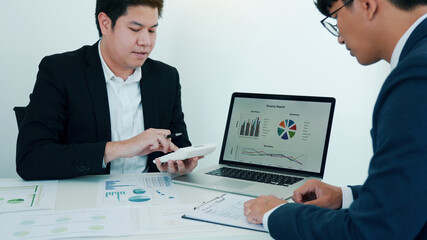 Teamwork with business people analysis cost graph on desk at meeting room.