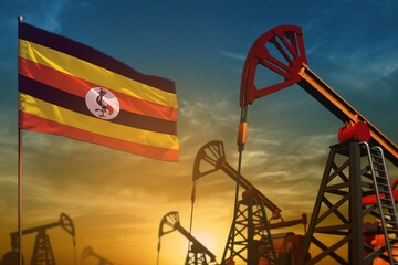 Uganda oil industry concept. Industrial illustration - Uganda flag and oil wells against the blue and yellow sunset sky background - 3D illustration