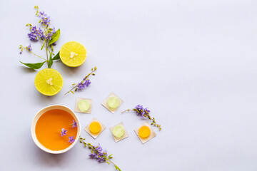 cough sore throat pastille pills from herbal honey and lemon with purple flowers arrangement flat lay style on background white