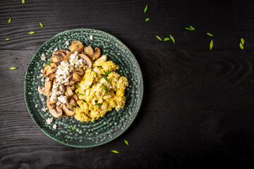Scrambled Egg for Breakfast. Fried egg with Mushrooms and Cottage Cheese on plate, top view, copy space