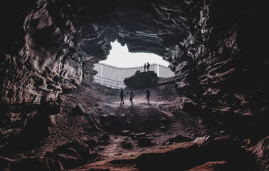 people exploring mysterious cave. Cave explorers and travelers.Outdoor adventure.