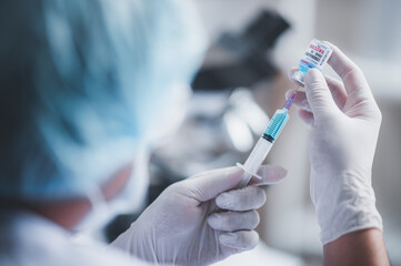 fight against COVID-19, coronavirus vaccine research in laboratory, professional scientists holds...