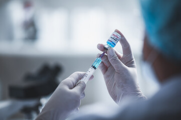 fight against COVID-19, coronavirus vaccine research in laboratory, professional scientists holds...