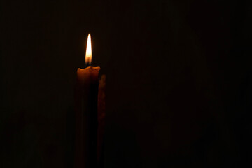 A burning candle in the night