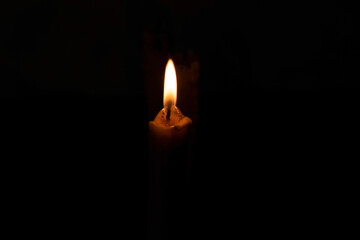 A burning candle in the night
