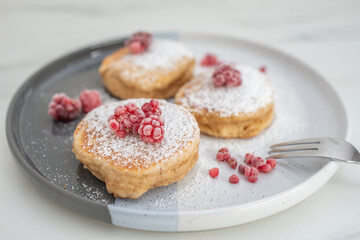 Tasty american pancakes with raspberries on a table