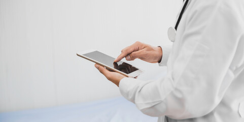Doctor finger touching screen on digital tablet closeup