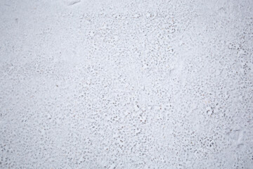 Snow texture on the asphalt. Winter background