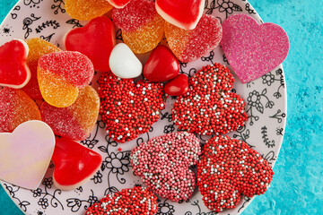 Valentine's day or romantic dinner with candy hearts on a blue background