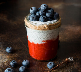 Homemade healthy chia pudding with coconut milk, strawberry puree and berries, natural clean food, vegetarianism