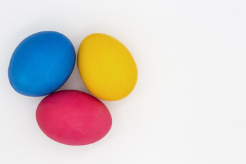 Colored Easter eggs lie on a white background.
