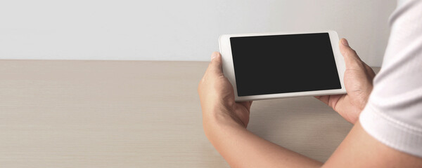 Hands holding  tablet touch computer gadget with isolated screen