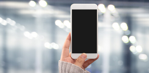 Hand holding smartphone device touching screen