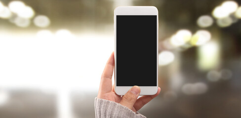 Hand holding smartphone device touching screen