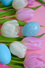 Obraz na płótnie Canvas Easter holiday. tulips flowers,blue easter eggs set on a light pink background.Easter eggs and spring flowers in pastel colors set.Spring festive easter background.Easter symbol.