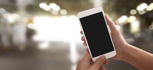 Hand holding smartphone device touching screen