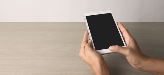 Hands holding  tablet touch computer gadget with isolated screen