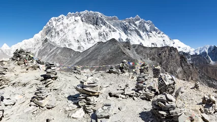 Papier Peint photo Lhotse View from top of Chhukung hill over Lhotse wall with rock cairns in the foreground, Everest Base Camp trek, Nepal