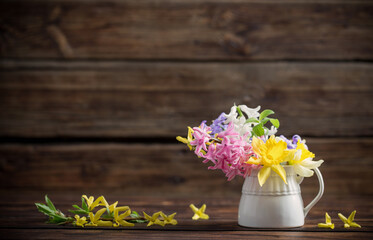 beautiful spring flowers on dark old wooden background
