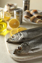 Concept of tasty lunch with fresh herring fish on white textured background