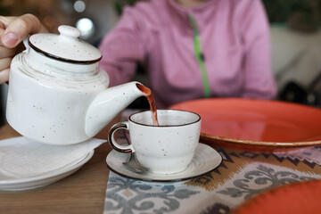 Woman pouring fruit tea