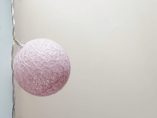 Wicker pink ball with a light bulb. Concept for designers. Copy space