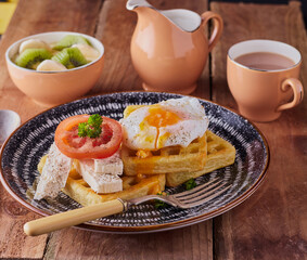 Waffles with poached egg and feta cheese.