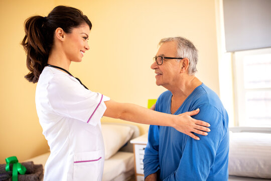 Nursing home doctor providing care to a senior man resident