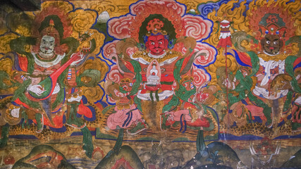 Colorful wall painting at the entrance of historical Jampey lhakhang temple complex in Bumthang valley, Bhutan representing the guardians of the cardinal directions