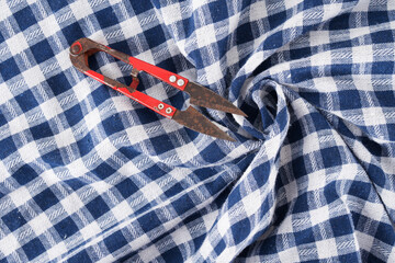 Blue and white plaid fabric and scissors

