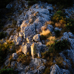 Some stones in the mountain illuminated by the sun during the sunrise. Rocky environment