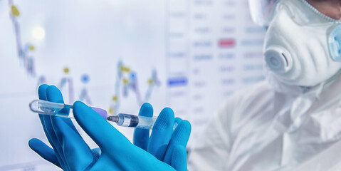 Up and fall of stock market economy finance exchange due to coronavirus vaccine. Nurse holding syringe vaccination against Covid-19 world