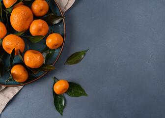 juicy tangerines with leaves on a grey background with copy space . top view. Close up view in high resolution