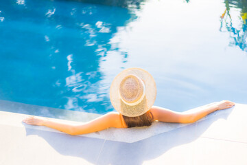 Fototapeta na wymiar Portrait beautiful young asian woman enjoy relax around swimming pool