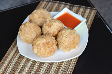 five pieces of meatball with chili sauce