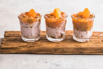 Chia pudding with persimmon in glasses with hearts persimmon