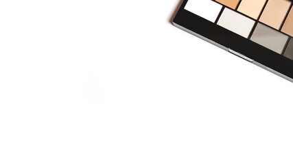 neutral brown eye shadow palette on white background. Female decorative cosmetics. Close up. Copy space. Flat lay